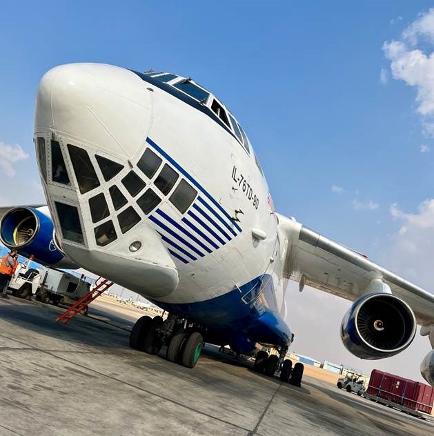 IL-76 airplane on tarmac, blue skies in background. Urgent air charter to Egypt.