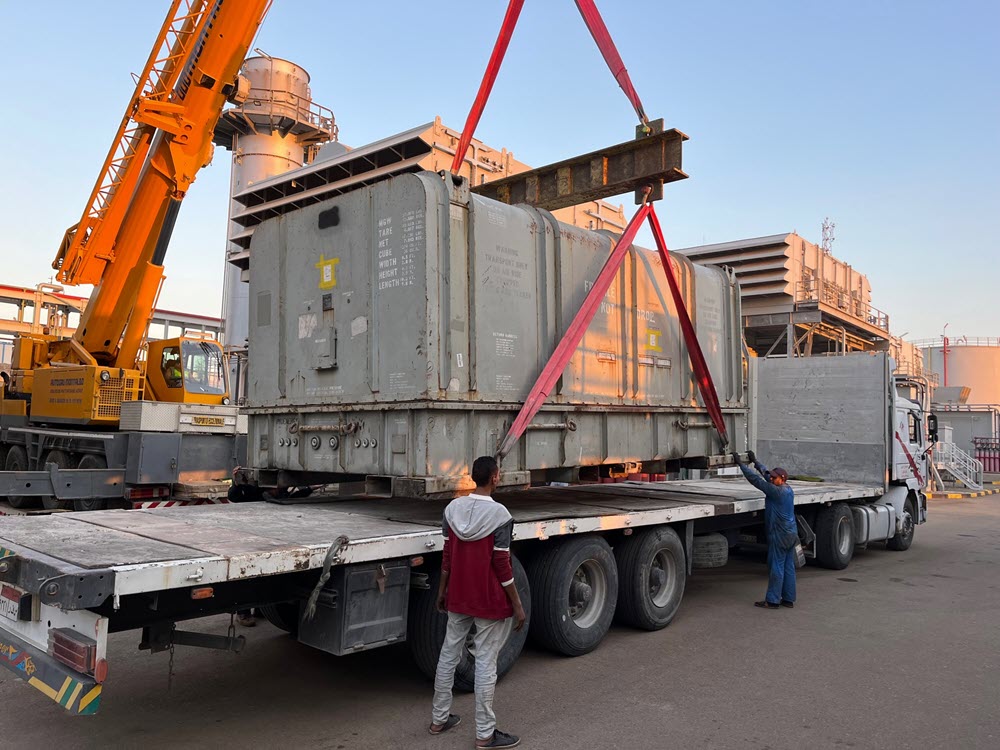 full shipping can being loaded onto a trailer. loading beam and lashing support weight of full container. These were transported from Egypt to USA via air charter.